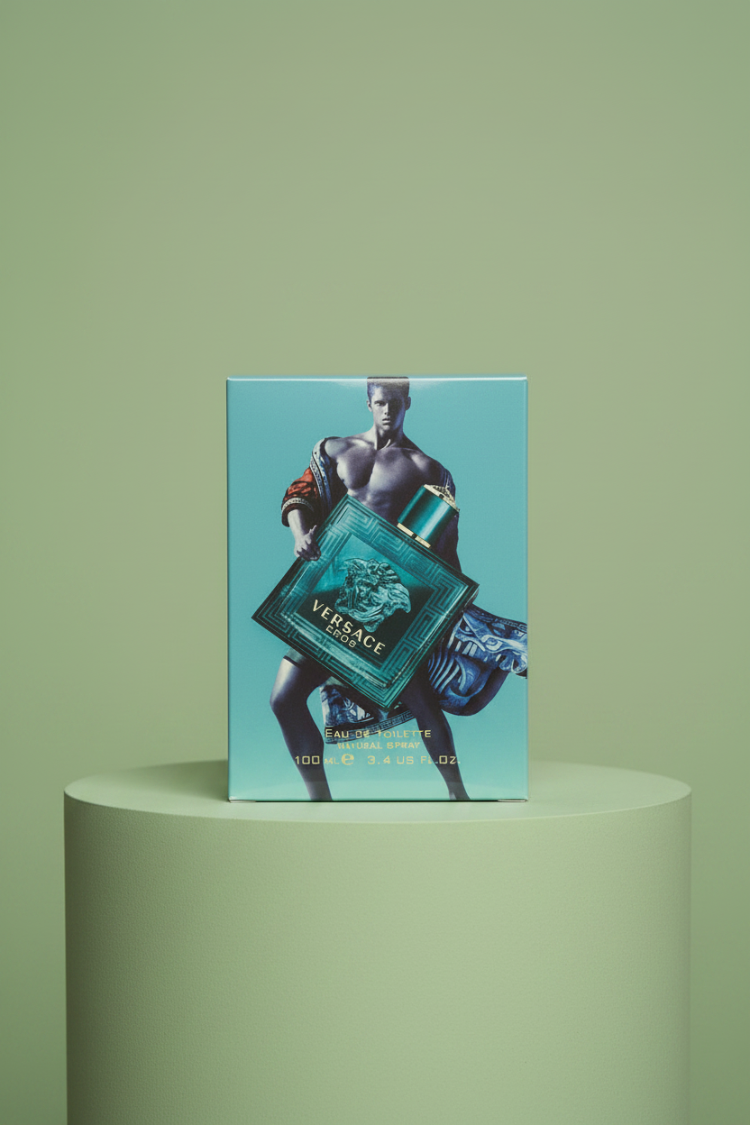 Hand holding a Versace perfume box against a green background