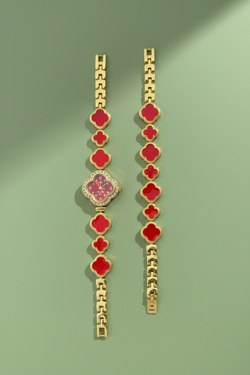 Bracelets with red and gold design on a branded card held by a hand outdoors.
